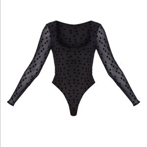 Black Polka Dot body suit from Pretty Little Thing